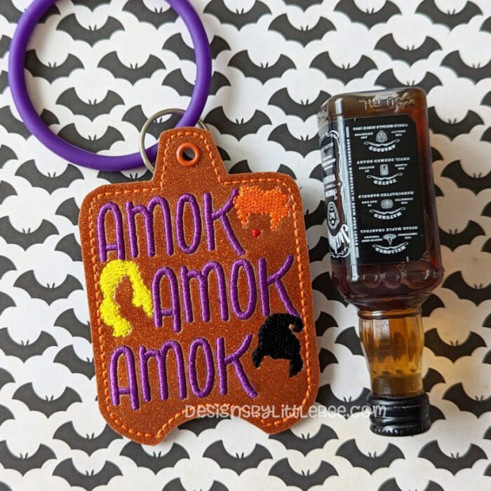 Amok! Nip Holder Snap Tab & Eyelet Fob